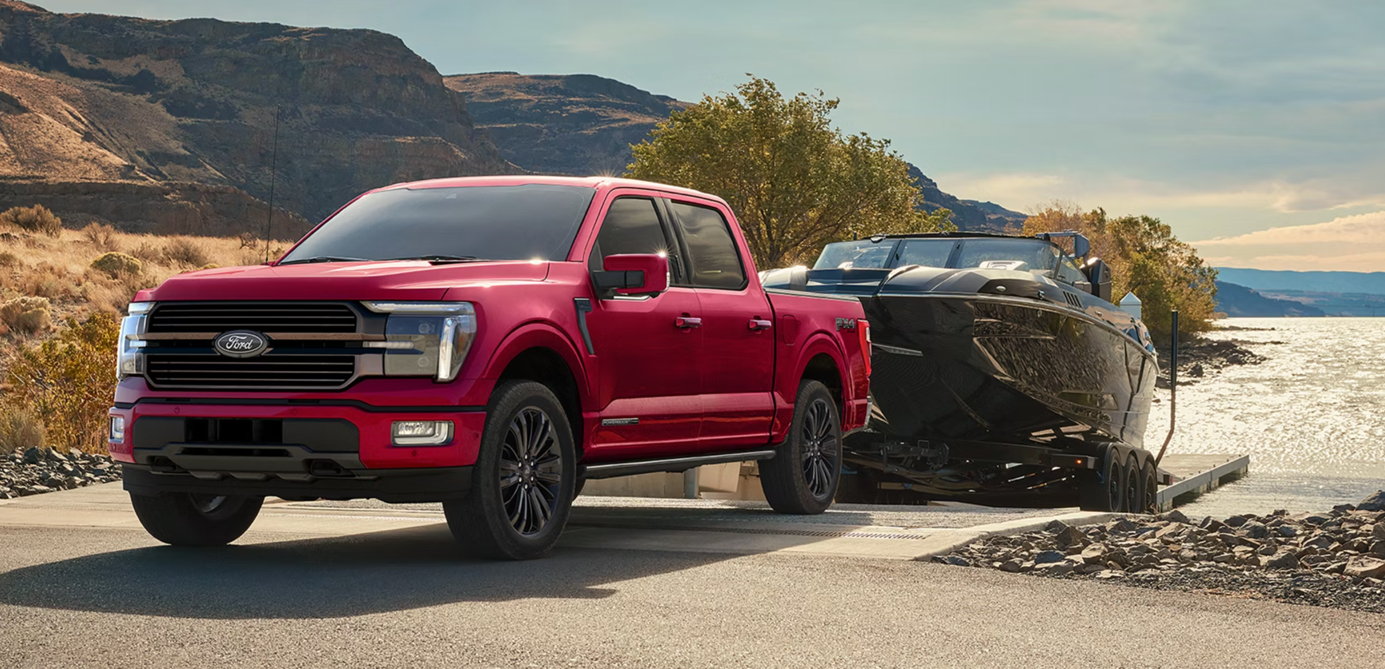 New red Ford F-150 towing boat near Parkersburg, WV